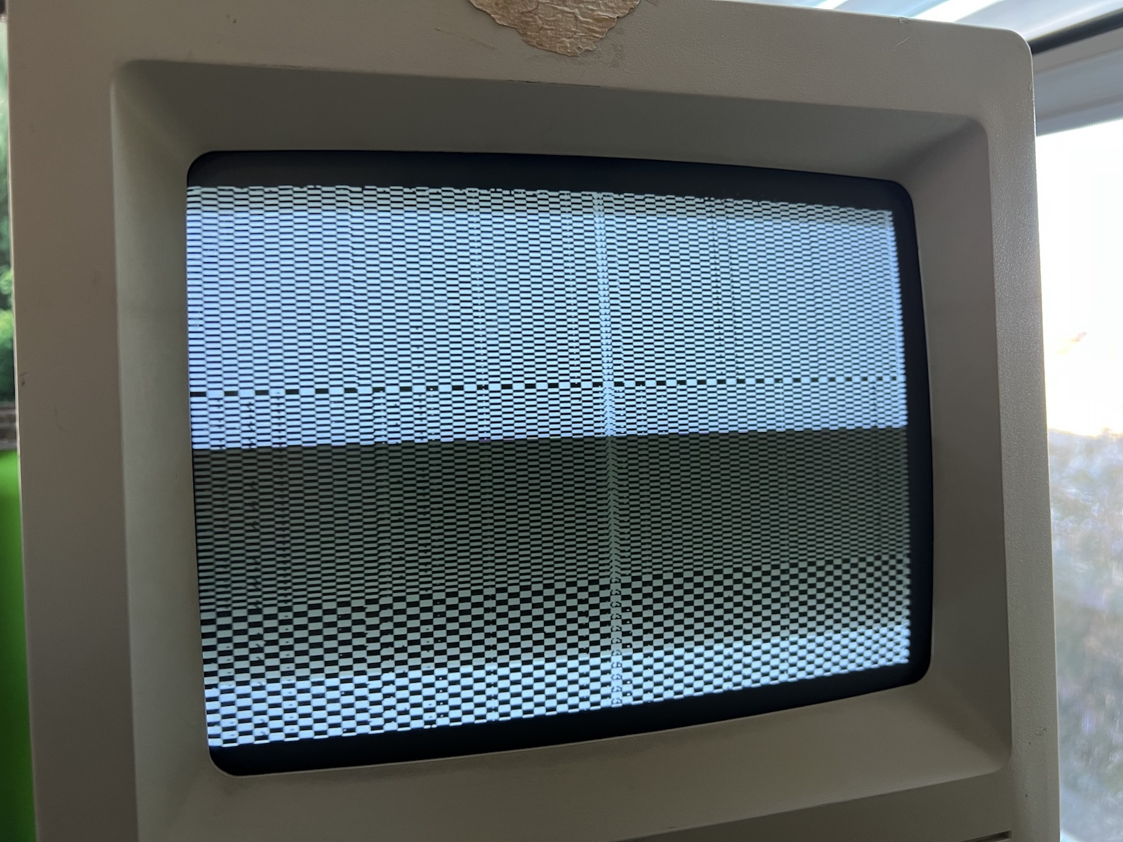 The screen of a Macintosh SE/30, showing a checkerboard simasimac pattern.