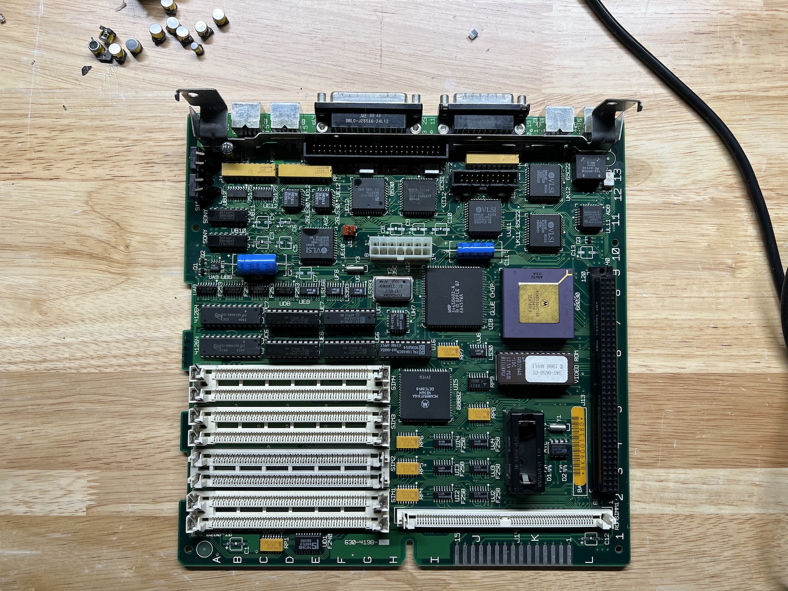 A Macintosh SE/30 logic board with all the capacitors removed.